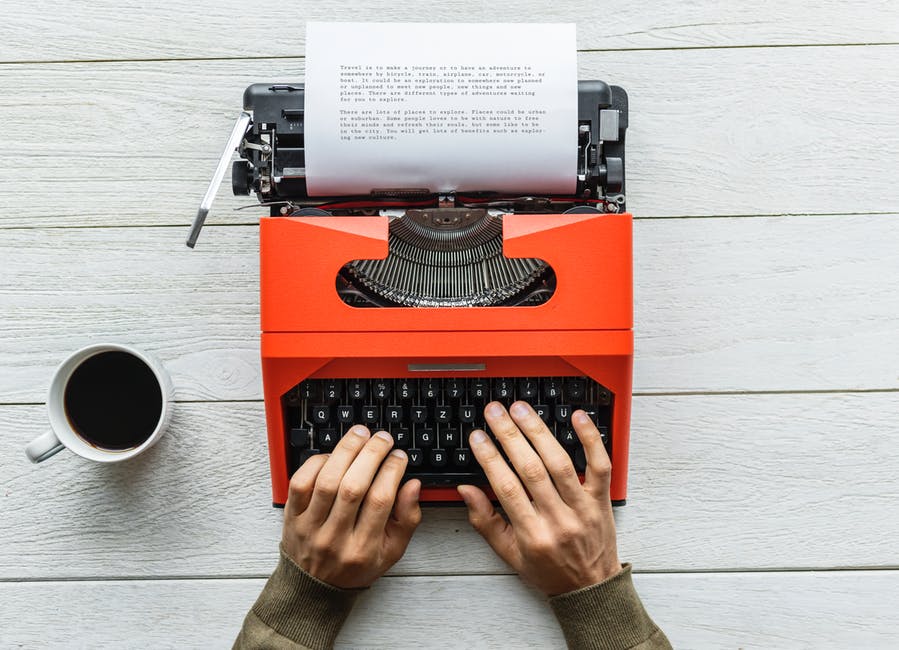 person typing content on a typewriter