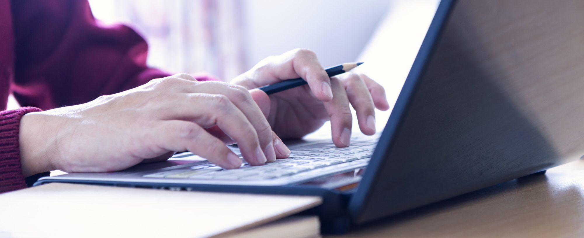 person writing on laptop