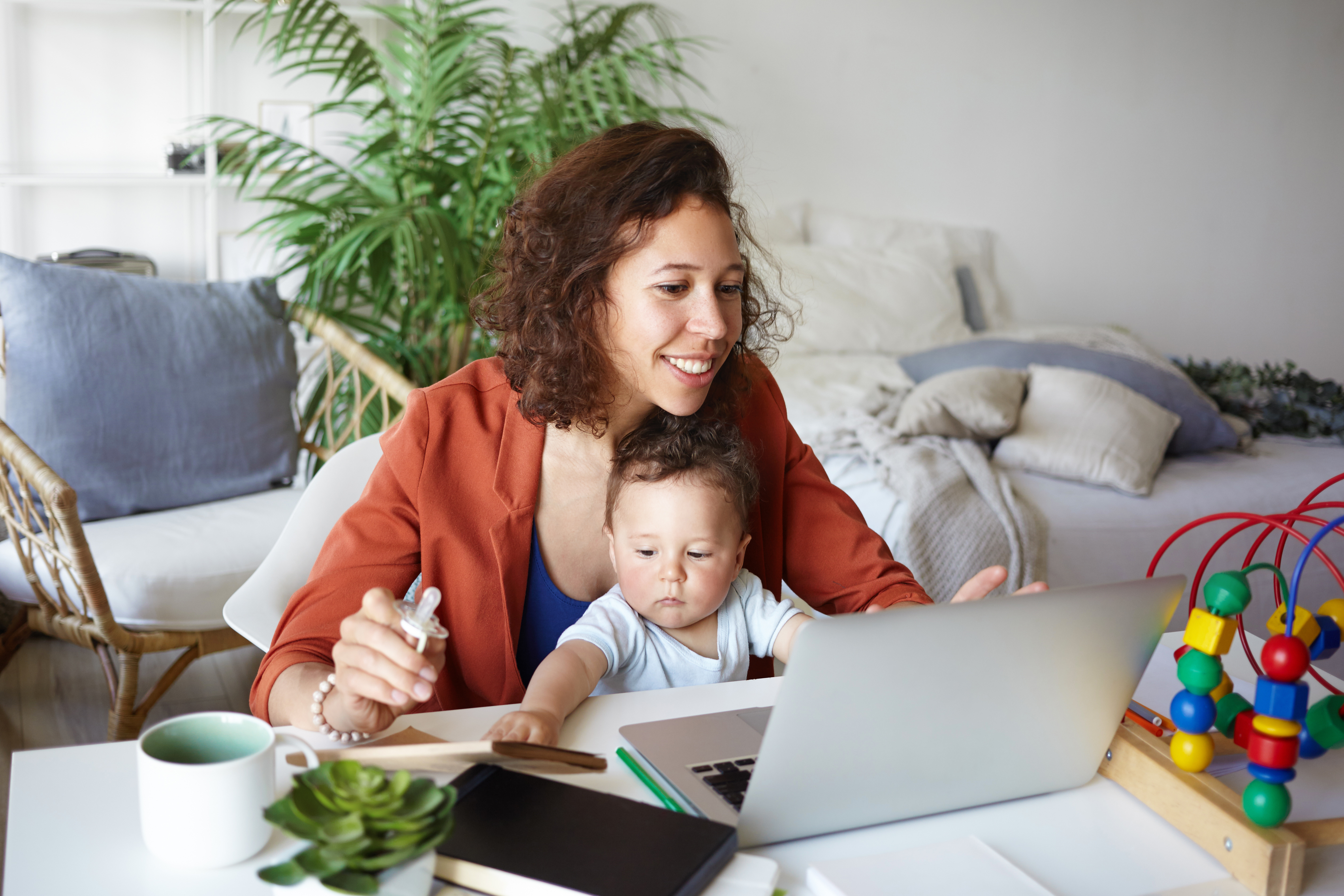 mother working with kid on lap