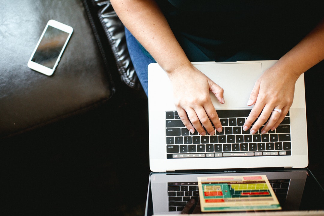 person typing on laptop