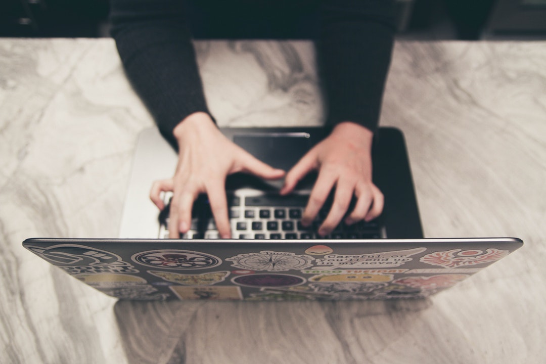 woman typing on laptop