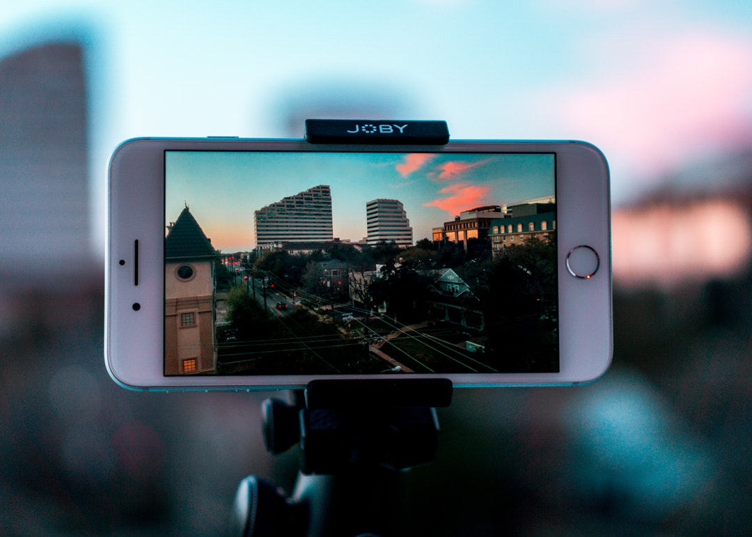 smartphone taking video of city