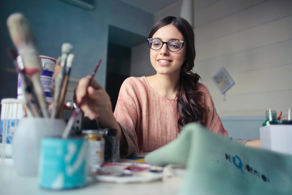 artist at desk painting